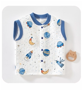 Close-up of quilted baby vest featuring space cartoon prints with planet and UFO motifs