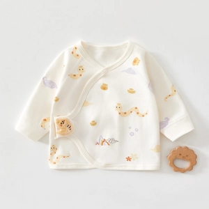 Detail of newborn cotton kimono top with cute Chinese zodiac snake and fortune pouch prints
