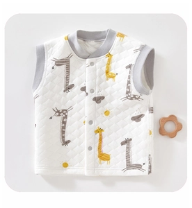 Detailed macro view of quilted baby vest featuring cute yellow giraffe patterns and snaps