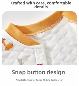 Detail of infant quilted vest showing neck lining, giraffe embroidery and snap fastener