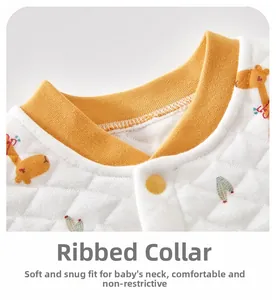 Detail of baby quilted vest with giraffe prints and ribbed neckline on yellow fabric