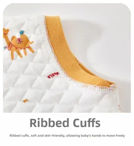 Close-up of ribbed cuffs and soft quilted fabric with camel print on baby vest