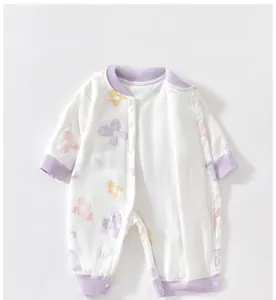 Macro detail of baby romper showing flower print and snap buttons on cotton fabric