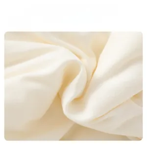 Close-up of soft white quilted cotton fabric showing delicate texture and high comfort