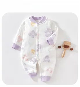 Detail of baby long-sleeve cotton romper with floral pattern and snap buttons