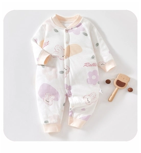 Detail of baby floral onesie showing soft cotton fabric and pink ribbed cuffs