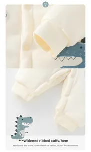 Detail of ribbed cuffs and dinosaur print on baby winter romper with snap buttons