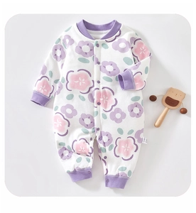 Close-up of baby floral cotton romper with purple ribbed trims and snap button closure