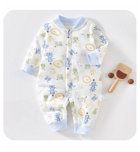 Close-up of baby romper with traditional Chinese characters and wooden bear toy