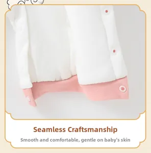 Detailed close-up of smooth flat-seam stitching and snap buttons on baby romper