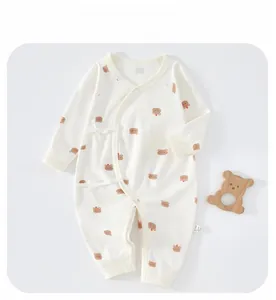 Close-up of baby romper with brown bear print and side-tie opening in soft cotton
