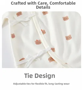 Close-up of baby romper with cotton fabric, cute bear print and side tie strings