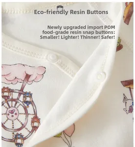 Close-up of food-grade POM resin snap buttons on a soft cotton baby bodysuit
