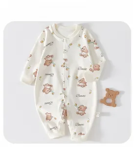 Detail of baby romper with teddy bear print, snap buttons and ribbed cuffs