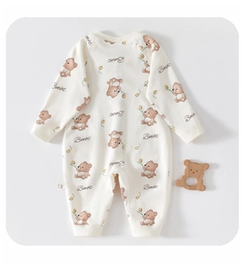 Detailed view of baby romper featuring brown cartoon bear prints and size label