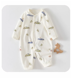 Detail of baby cotton romper with vintage car print and wooden toy on grey background