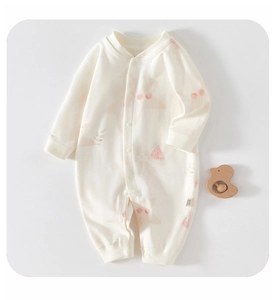 Detail of baby cotton romper featuring cute fruit prints and convenient snap buttons