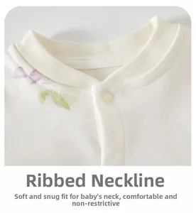 Close-up of baby bodysuit ribbed neckline with purple floral pattern on soft cotton fabric