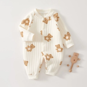 Detailed view of baby quilted cotton romper featuring cute bear prints and ribbed texture