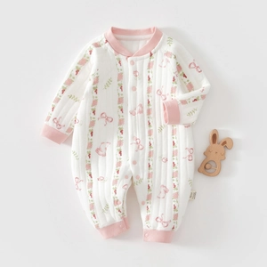Macro detail of infant cotton romper with pink floral bunny print and snap buttons