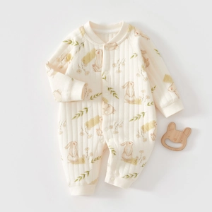 Flat lay of a quilted baby romper with rabbit prints and vertical texture on white base