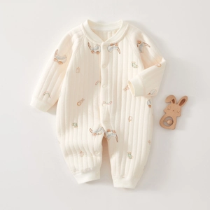 Detailed view of quilted cotton baby romper featuring playful rainbow and bunny prints