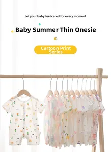 Detail of short-sleeve baby rompers with cute cartoon prints on wooden hangers