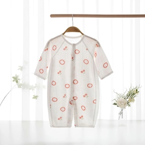 Close-up of baby romper featuring breathable mesh fabric with red cherry and lion prints