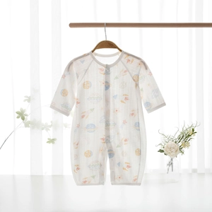 Detail of baby summer romper with colorful cartoon space prints and snap buttons