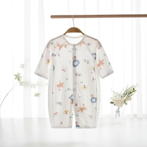 Detail of baby summer romper featuring breathable fabric and cartoon animal print