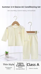 Close-up of 100% cotton summer baby sleepwear set with long sleeves and light yellow fabric