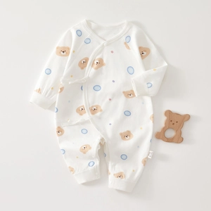 Detail of soft cotton baby romper featuring cute bear prints and easy-tie side closure