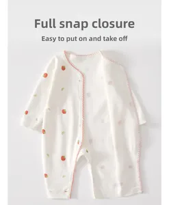 Detail of snap button closure on cotton baby romper with strawberry and bow print
