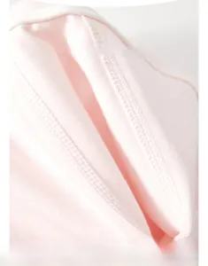 Close-up of baby romper soft pink cotton fabric showing high-quality stitching and texture