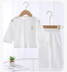 Detail of baby cotton pajama set with breathable mesh fabric and tree print