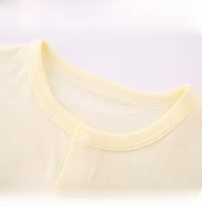 Close-up of baby ribbed cotton shirt neckline with a single snap button closure