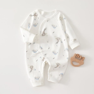 Detailed flat lay of soft cotton baby romper with ink bottle and flower prints