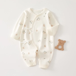 Detail of soft cotton newborn romper with cute bear print and side strap closure