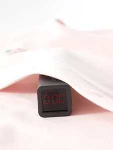 Pink newborn cotton romper being tested for safety to show zero fluorescence and chemicals