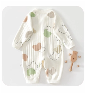 Close-up of baby romper showing soft ribbed cotton fabric and cute cartoon bear prints