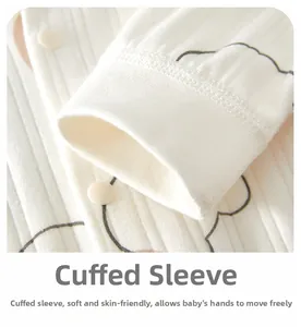 Detailed close-up of ribbed cotton baby romper cuffs with cloud pattern and snap buttons
