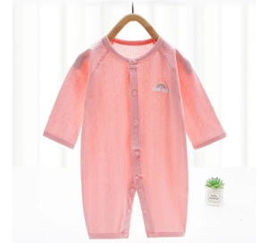 Detail of pink baby romper featuring rainbow embroidery and snap closure on hanger