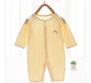 Close-up of yellow baby romper with breathable hollow stripes and rainbow embroidery