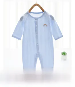 Close-up of light blue baby romper with breathable mesh fabric and rainbow embroidery