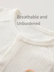White breathable knit baby bodysuit with rainbow embroidery patch and pointelle texture