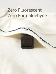 White cotton newborn romper showing Class A safety testing and zero fluorescence test