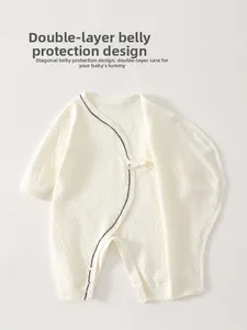 Detail of baby cotton romper featuring double-layer belly protection and side-tie design