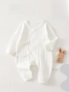 Detailed view of white cotton infant bodysuit with vertical stripes and side bow ties