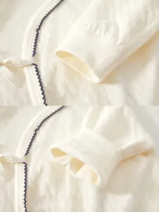 Detail of soft ribbed cuffs and tie closure on pure cotton white newborn baby bodysuit