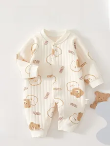 Close-up of quilted baby onesie with cute bear print and soft ribbed texture detail